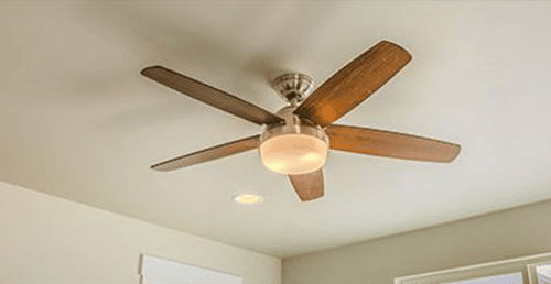 A wood-grain ceiling fan on a white ceiling
